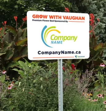 Outdoor sign in a flower bed